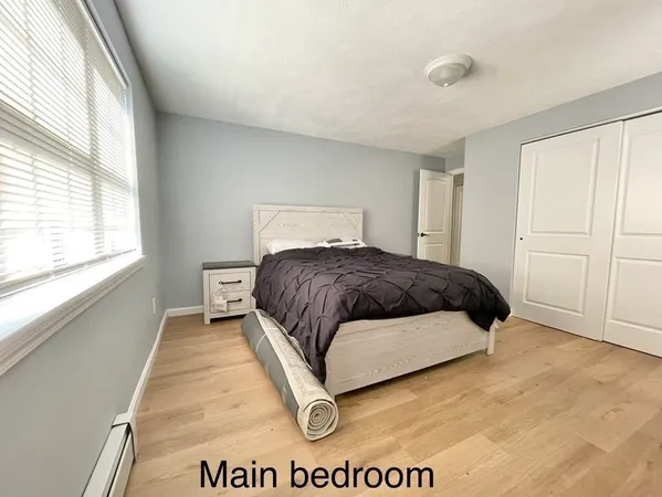 a bedroom with a bed and window