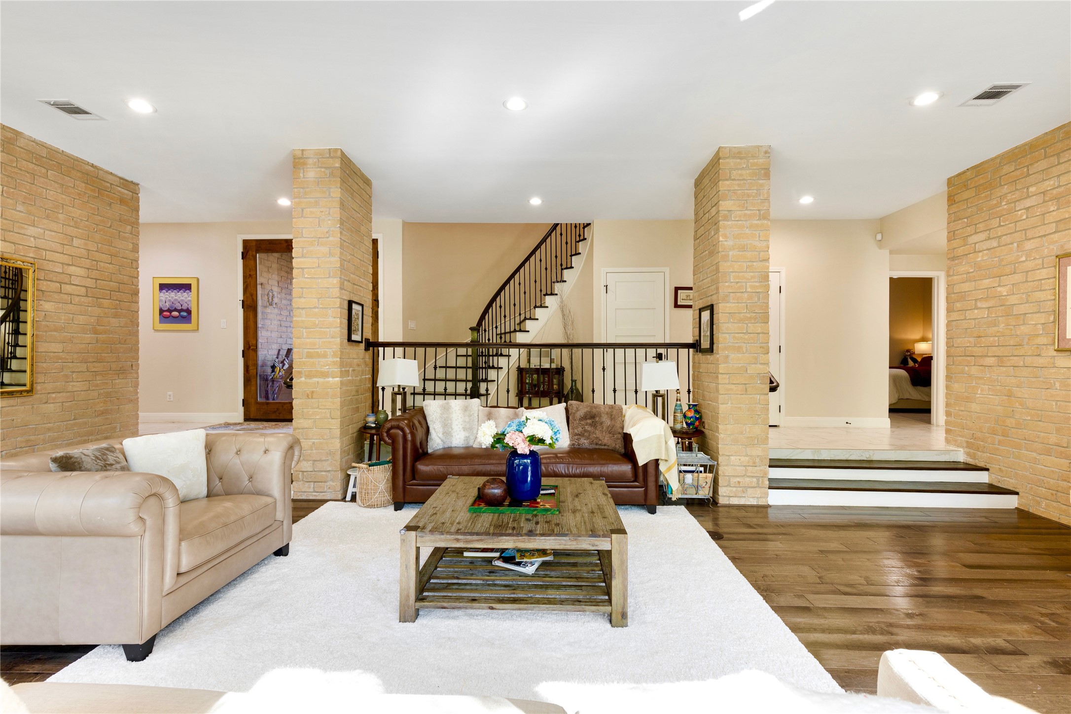 201 Vanderpool Lane, Unit 130 Houston, TX 77024 - Photo 5 of 41 The symmetrical brick columns create a quaint seating/reading nook and frames the circular staircase with wrought iron balusters beyond. Located to the right of the staircase is a coat closet and elevator.
