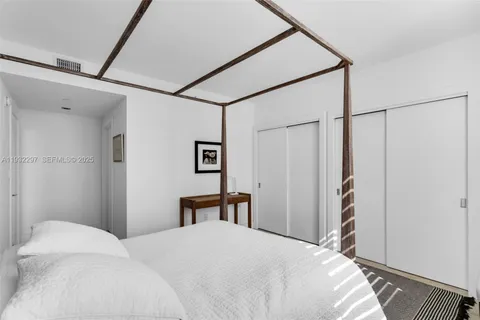 a bathroom with a sink a toilet a mirror and shower