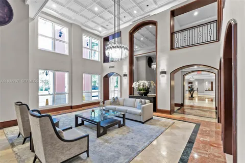 a living room with furniture and a floor to ceiling window