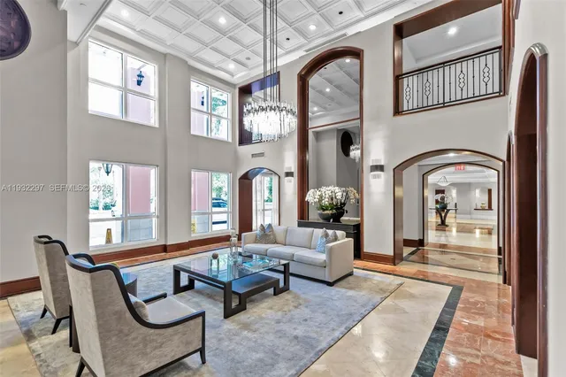 a living room with furniture and a floor to ceiling window