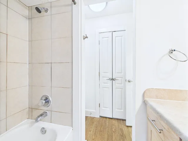 a bathroom with a tub a sink and a shower