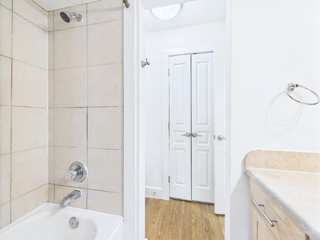711 West 32nd Street, Unit 126 Austin, TX 78705 - Photo 11 of 15 a bathroom with a tub a sink and a shower