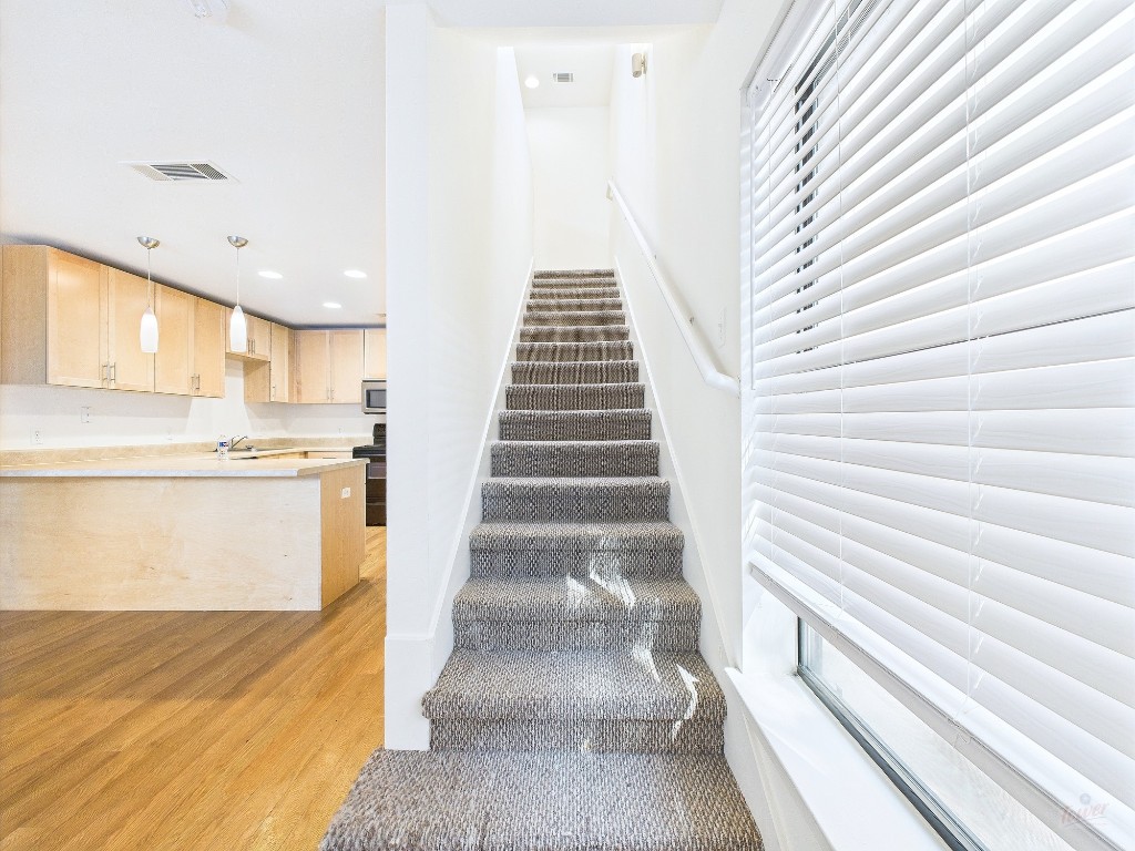 711 West 32nd Street, Unit 126 Austin, TX 78705 - Photo 7 of 15 a view of a kitchen with stairs and an entryway