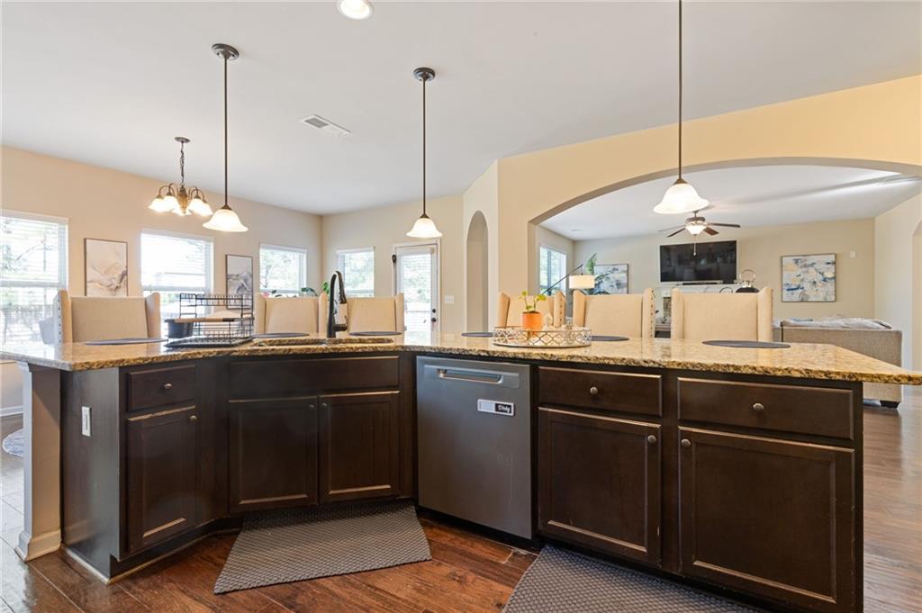 2352 Alexander Top Place Grayson, GA 30017 - Photo 22 of 66 a kitchen with stainless steel appliances granite countertop cabinets and a wooden floor