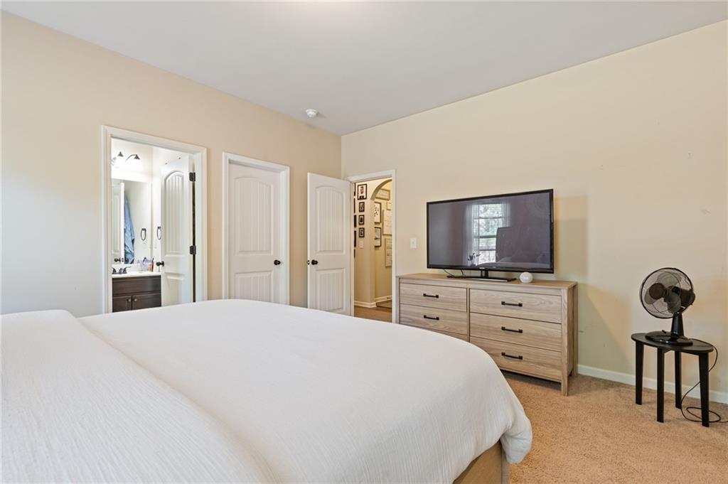2352 Alexander Top Place Grayson, GA 30017 - Photo 30 of 66 a bedroom with a bed and a flat screen tv