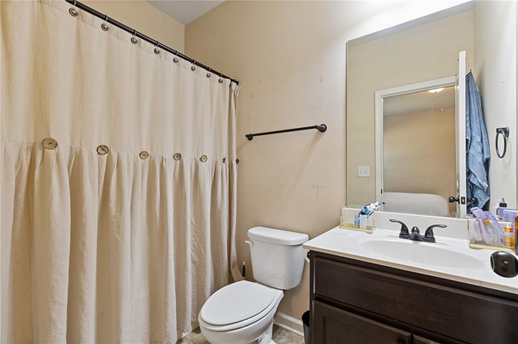 2352 Alexander Top Place Grayson, GA 30017 - Photo 31 of 66 a bathroom with a sink a toilet and a mirror