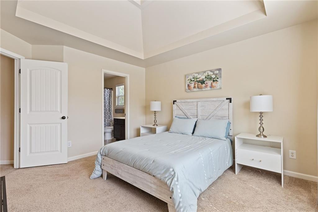 2352 Alexander Top Place Grayson, GA 30017 - Photo 35 of 66 a bedroom with a bed and a lamp