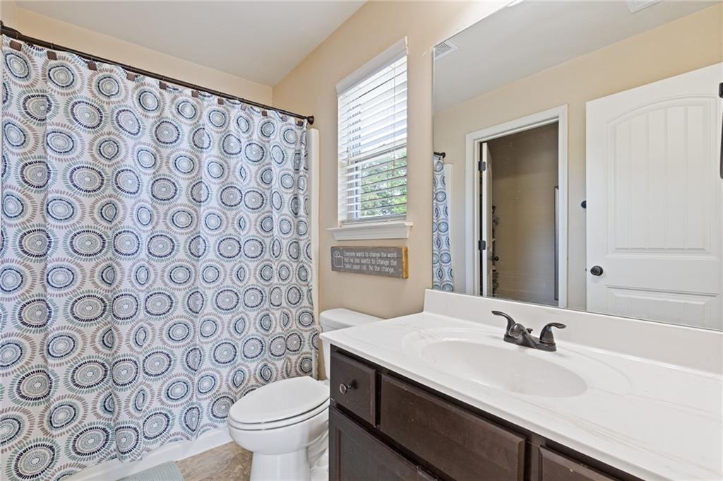 2352 Alexander Top Place Grayson, GA 30017 - Photo 36 of 66 a bathroom with a granite countertop sink a toilet and a mirror