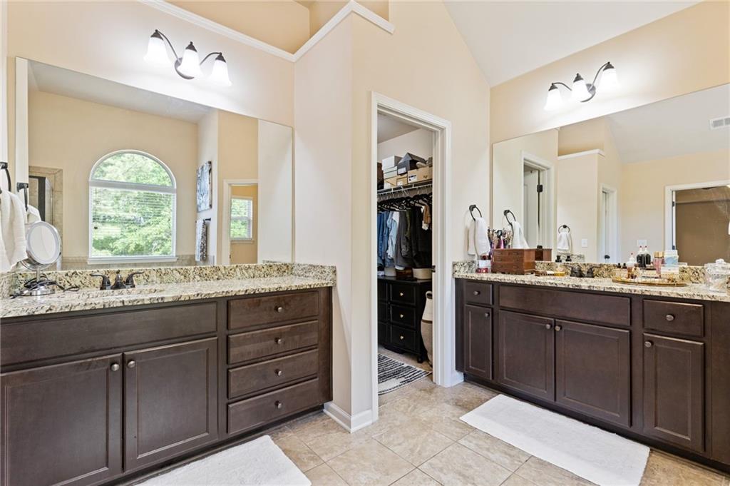 2352 Alexander Top Place Grayson, GA 30017 - Photo 43 of 66 a bathroom with a granite countertop sink a large mirror and a window