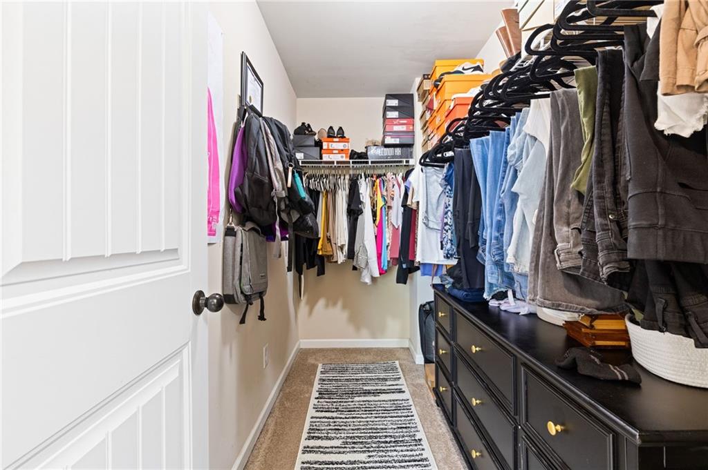 2352 Alexander Top Place Grayson, GA 30017 - Photo 45 of 66 a view of walk in closet with clothes and shoes