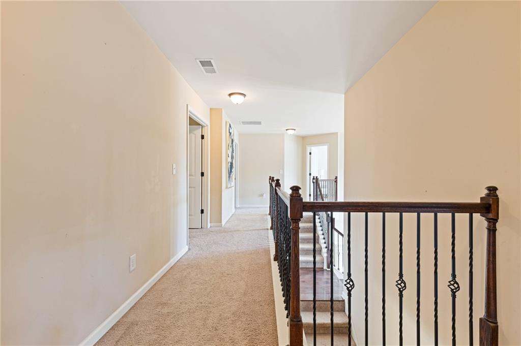 2352 Alexander Top Place Grayson, GA 30017 - Photo 55 of 66 a view of a hallway with wooden floor and staircase
