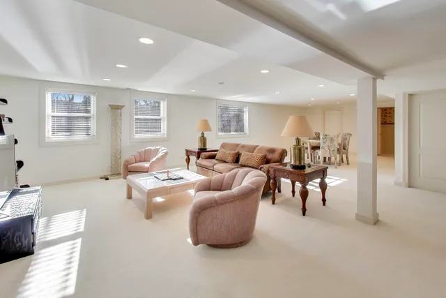 a living room with furniture and a dining table with wooden floor