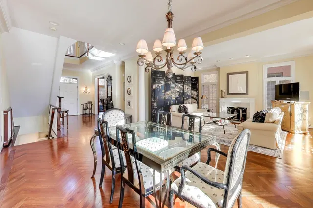 a view of a dining room with furniture wooden floor and chandelier