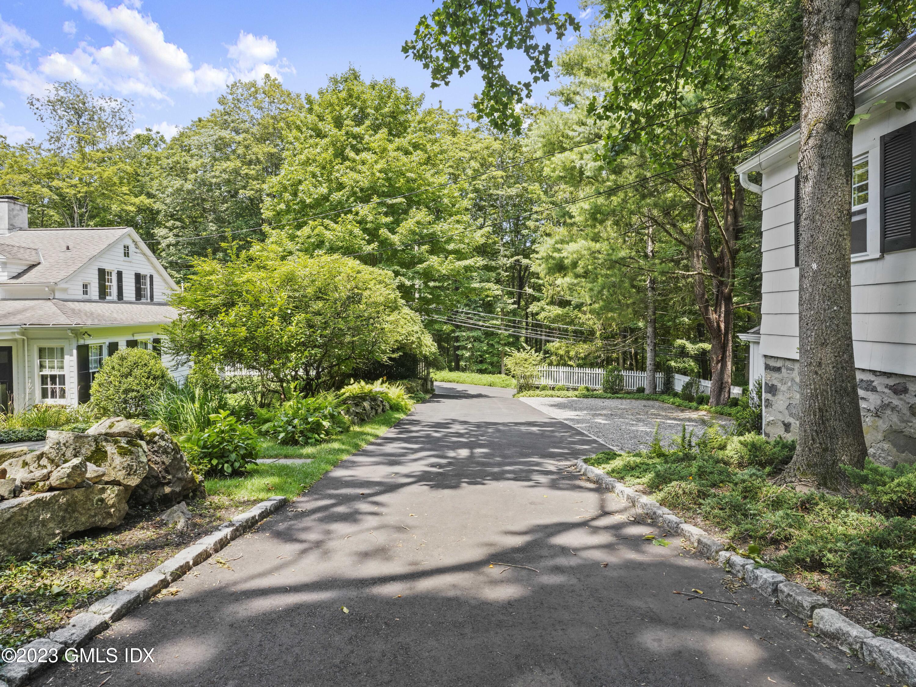 470 June Road, Unit STUDIO Stamford, CT 06903 - Photo 8 of 11 a front view of a house with a yard and fountain in middle