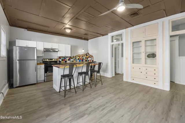 a view of a dining room with a table and chairs