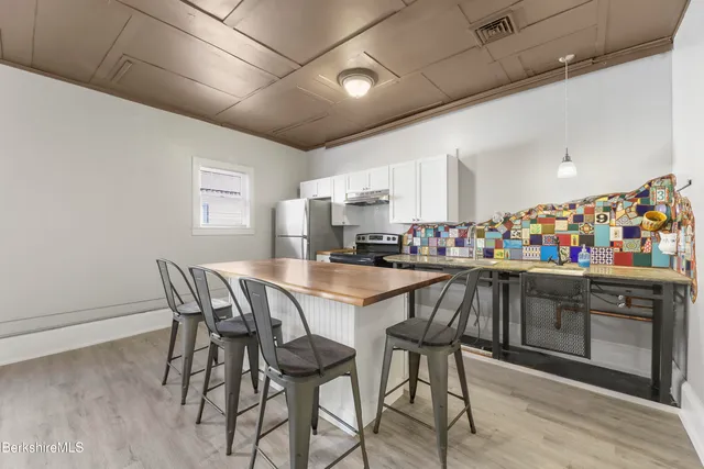 an empty room with windows and closet