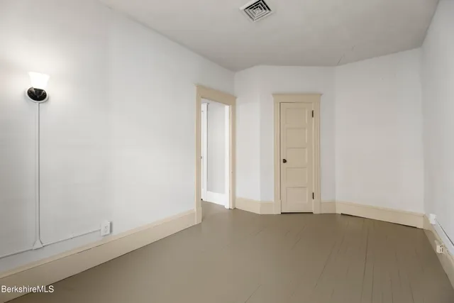 a view of staircase with railing and white walls
