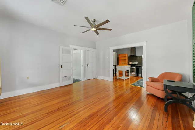 a view of a room with wooden floor