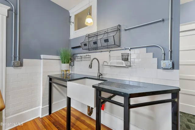 a view of a room with wooden floor