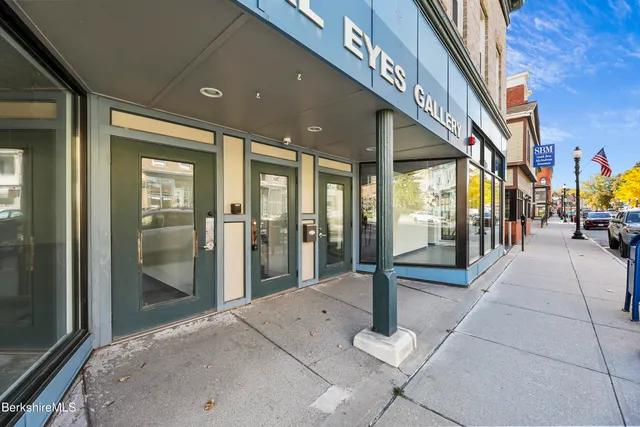 a dining room with furniture floor to ceiling window and potted plants