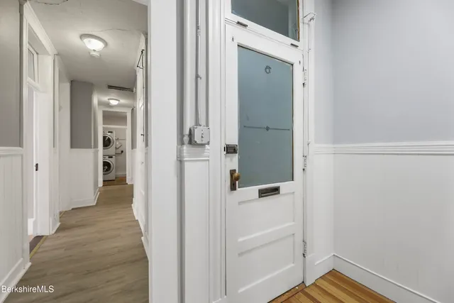 a kitchen with stainless steel appliances a table and chairs in it