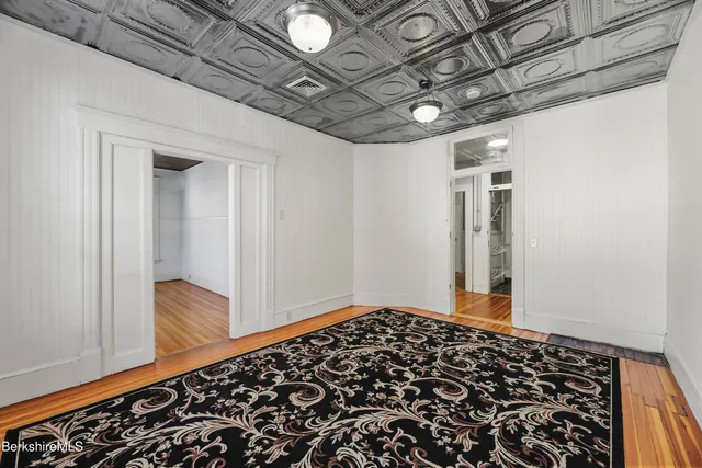 a kitchen with stainless steel appliances a stove and white cabinets