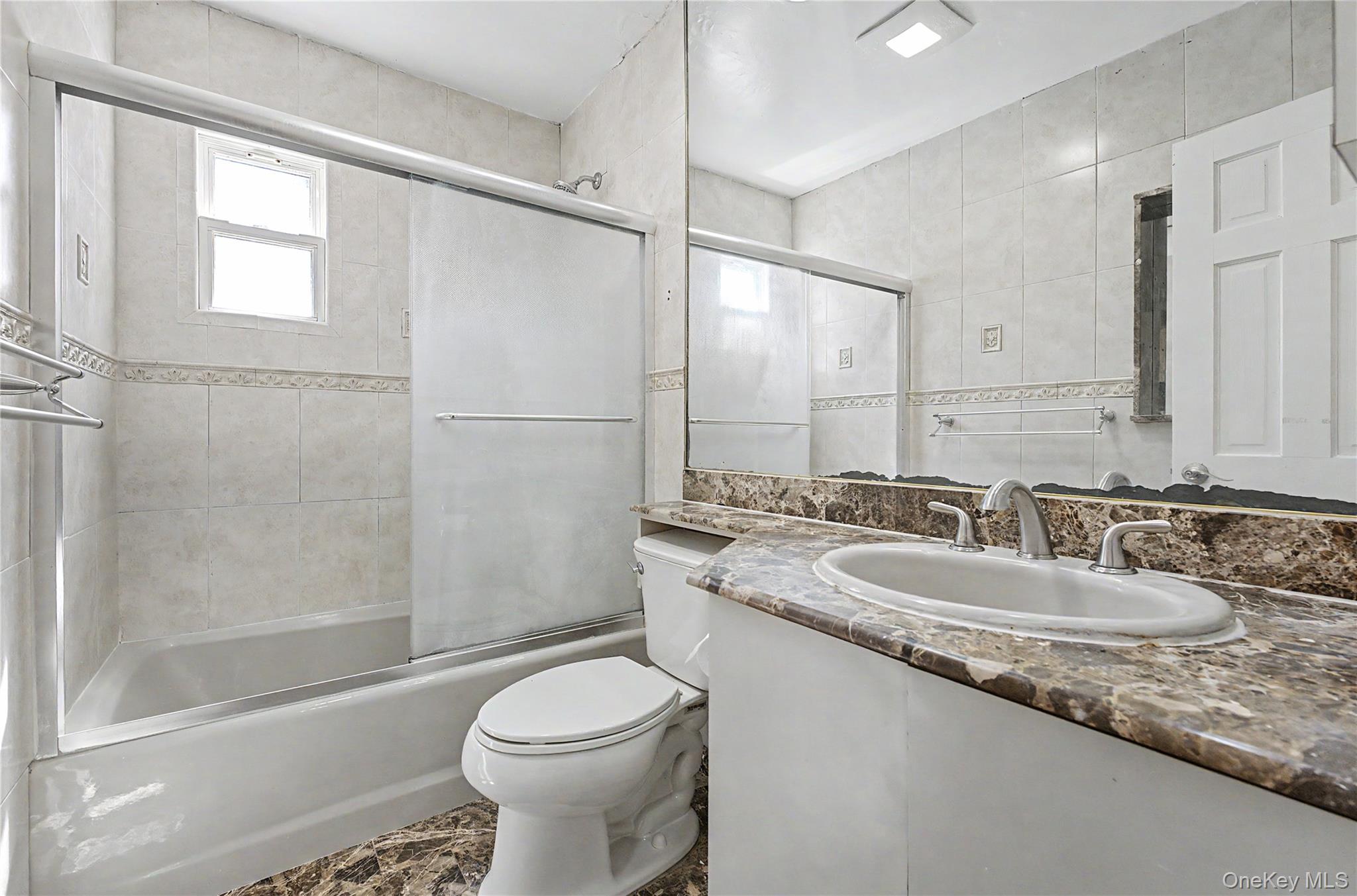 567 Oxford Road Cedarhurst, NY 11516 - Photo 14 of 31 a bathroom with a granite countertop sink toilet and shower