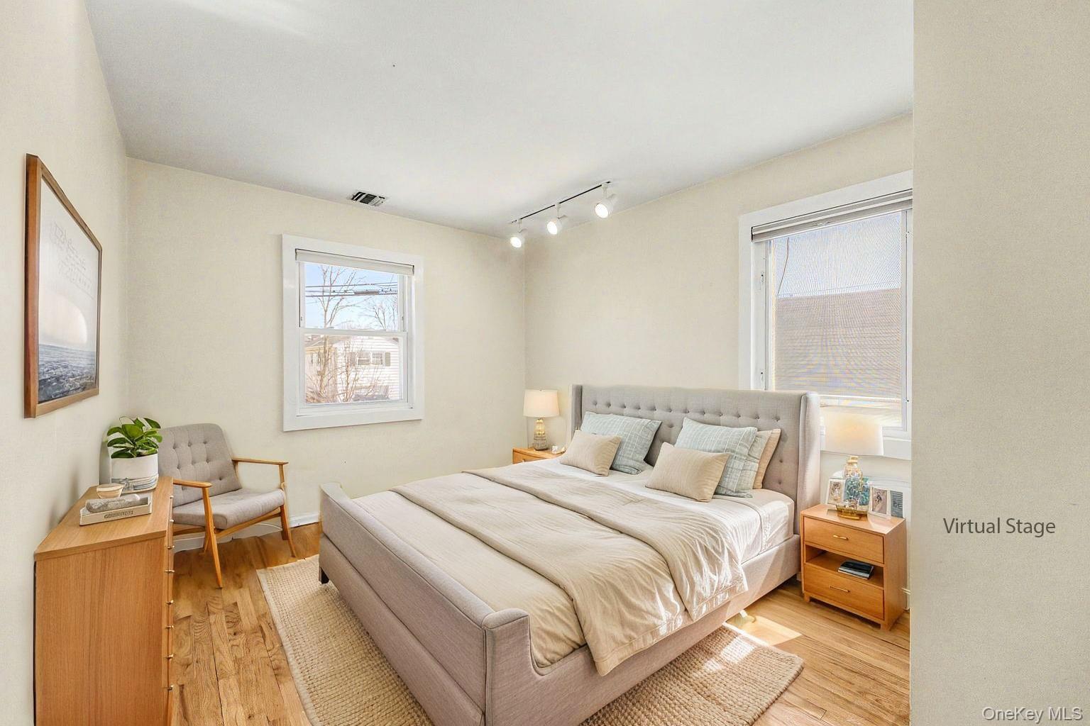 567 Oxford Road Cedarhurst, NY 11516 - Photo 15 of 31 a bedroom with a bed and wooden floor