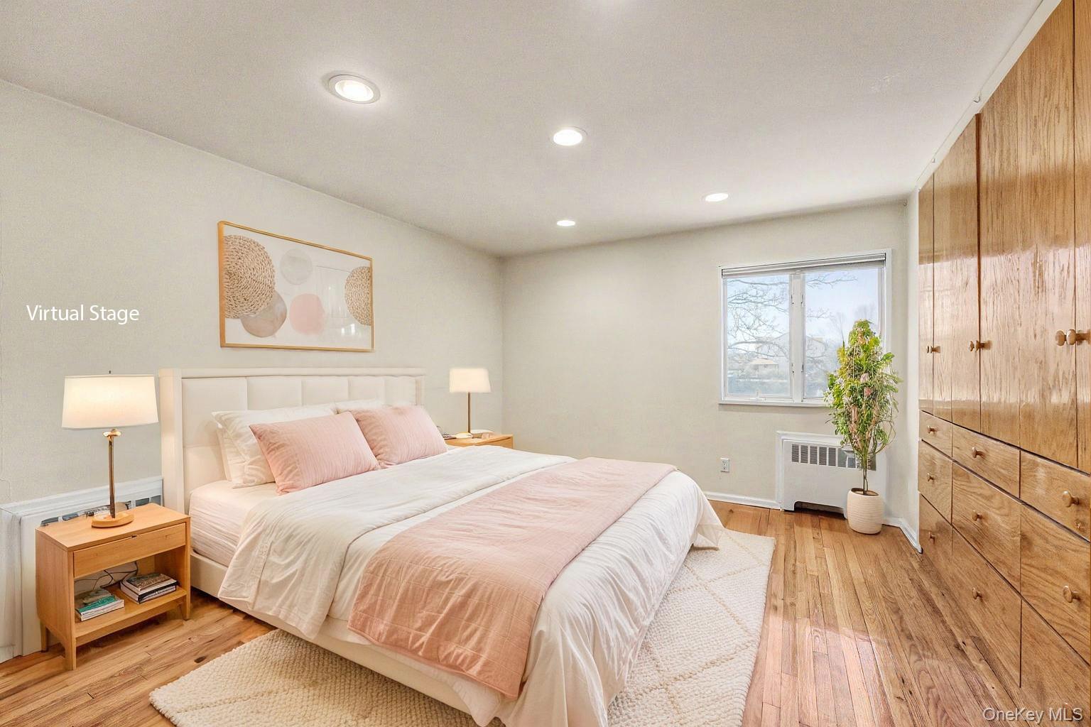 567 Oxford Road Cedarhurst, NY 11516 - Photo 18 of 31 a spacious bedroom with a bed and a wooden floor