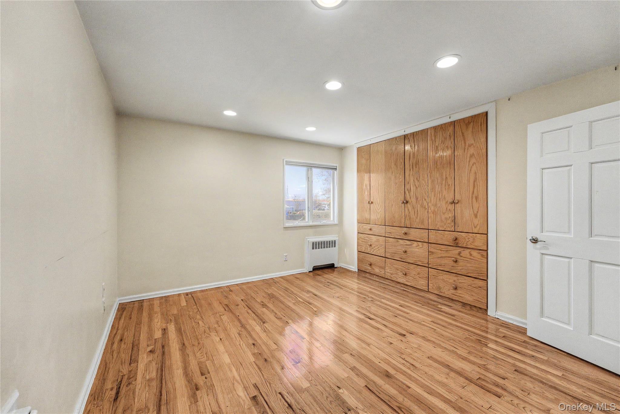 567 Oxford Road Cedarhurst, NY 11516 - Photo 20 of 31 a view of an empty room with wooden floor