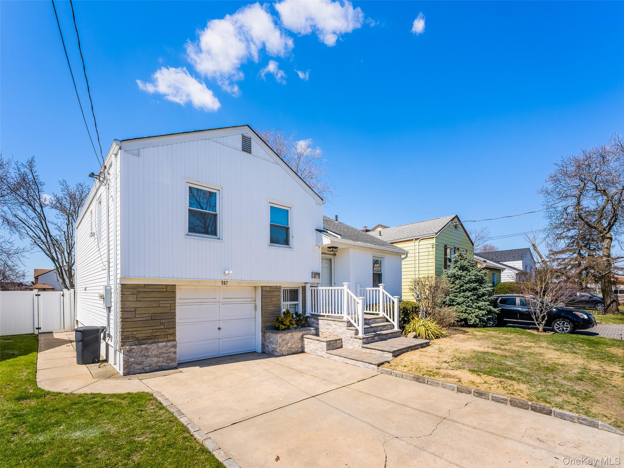 567 Oxford Road Cedarhurst, NY 11516 - Photo 2 of 31 a view of a house with a yard