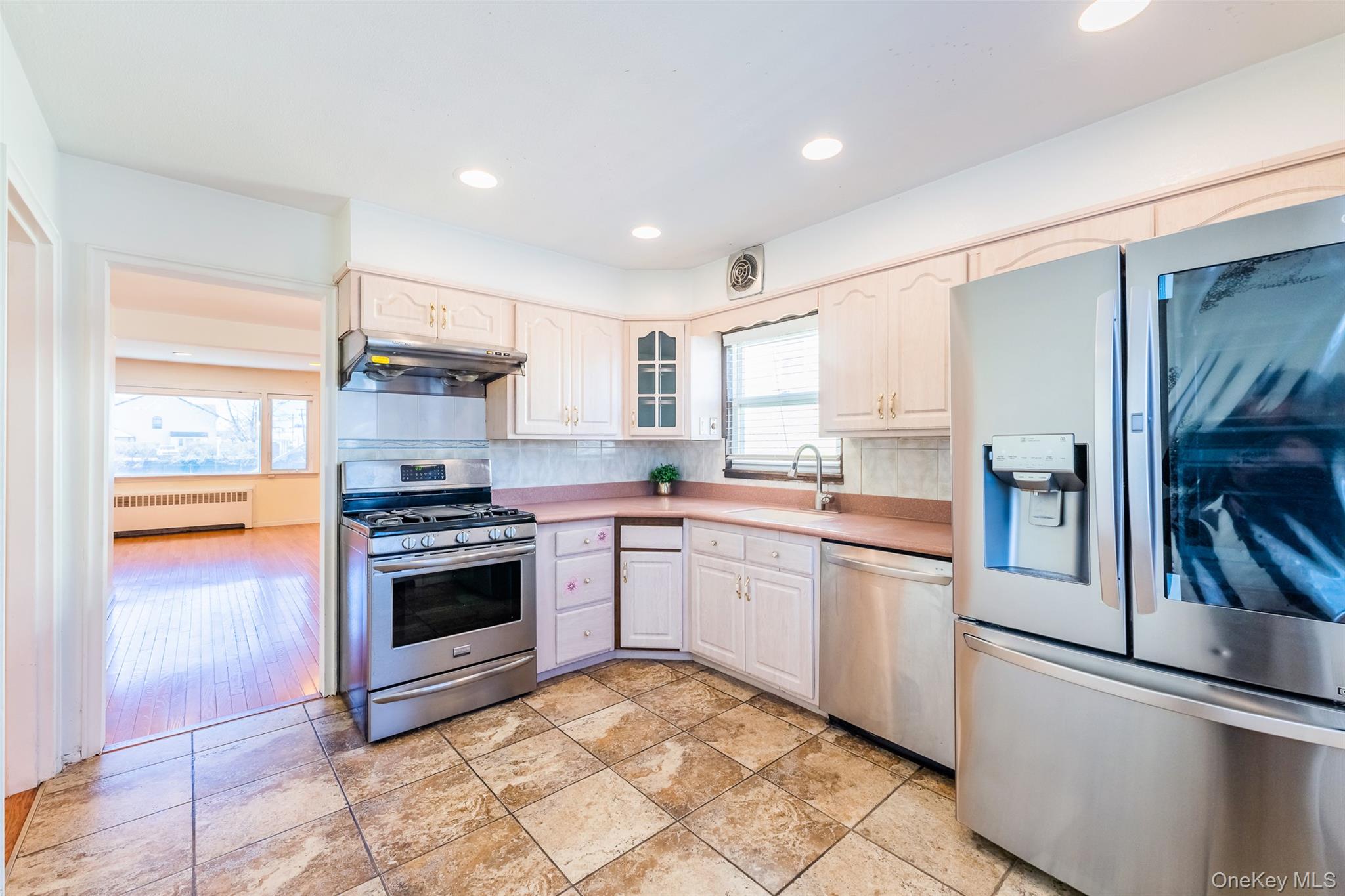 567 Oxford Road Cedarhurst, NY 11516 - Photo 4 of 31 a kitchen with stainless steel appliances granite countertop a refrigerator sink and stove