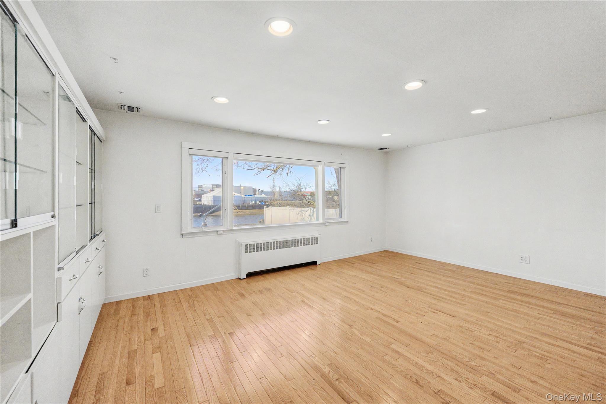 567 Oxford Road Cedarhurst, NY 11516 - Photo 5 of 31 a view of an empty room with a window