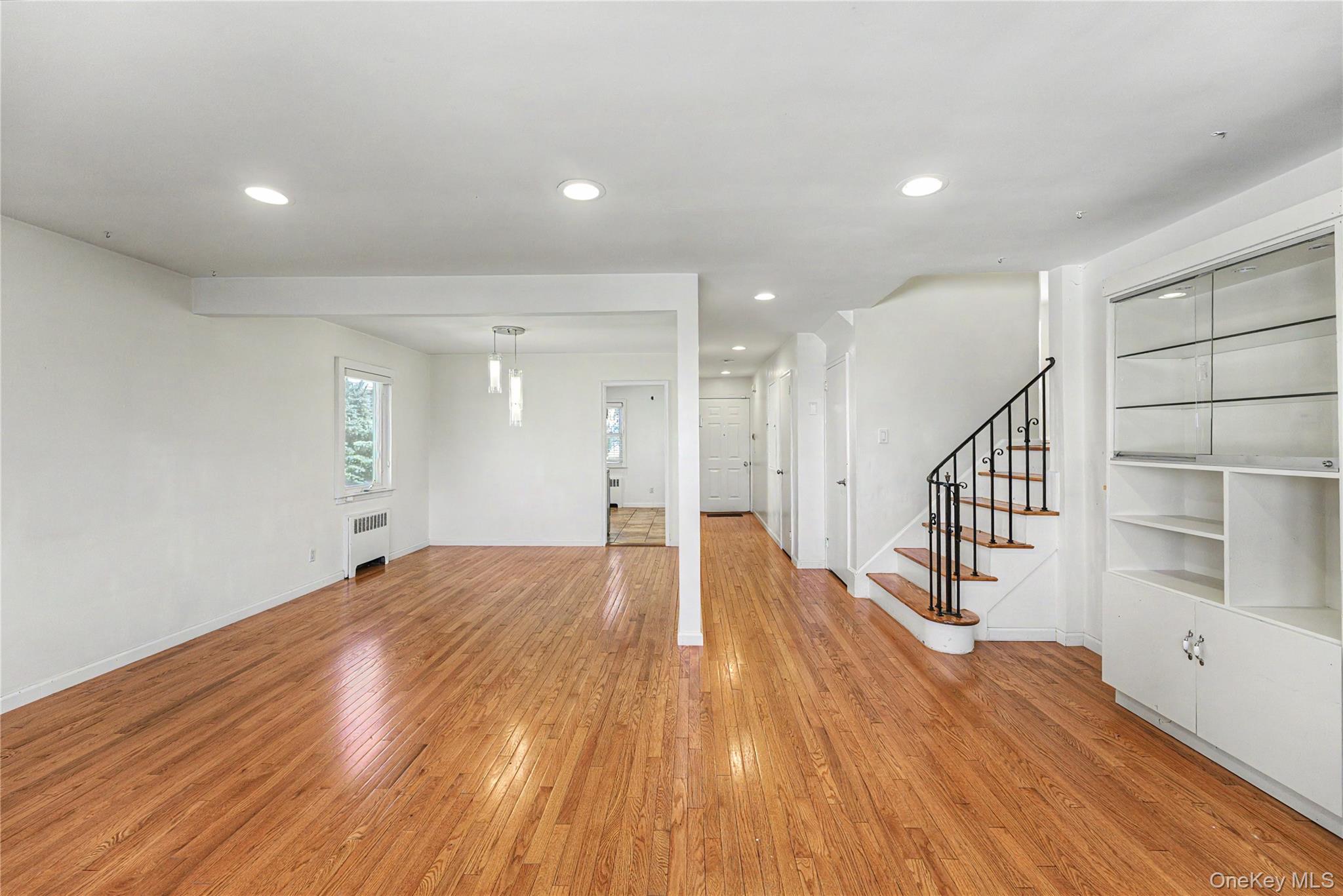567 Oxford Road Cedarhurst, NY 11516 - Photo 9 of 31 a view of empty room with wooden floor and windows