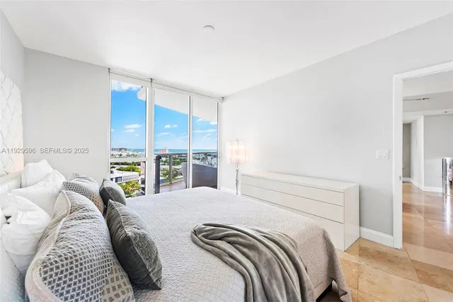 a bedroom with a bed a table and chair