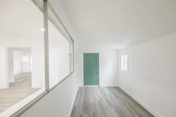 a view of an entryway with wooden floor