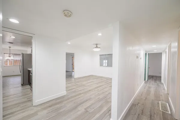 a view of a hallway with wooden floor
