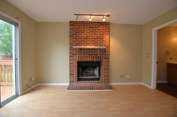 a view of empty room with a fireplace