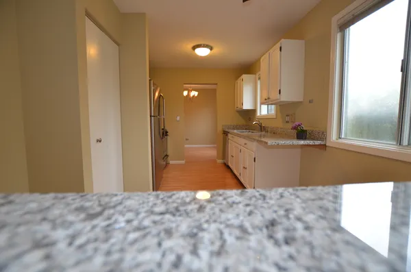 a bathroom with a sink vanity granite and a mirror