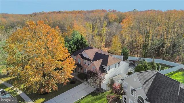 a dining room with stainless steel appliances kitchen island granite countertop a dining table chairs and view living room