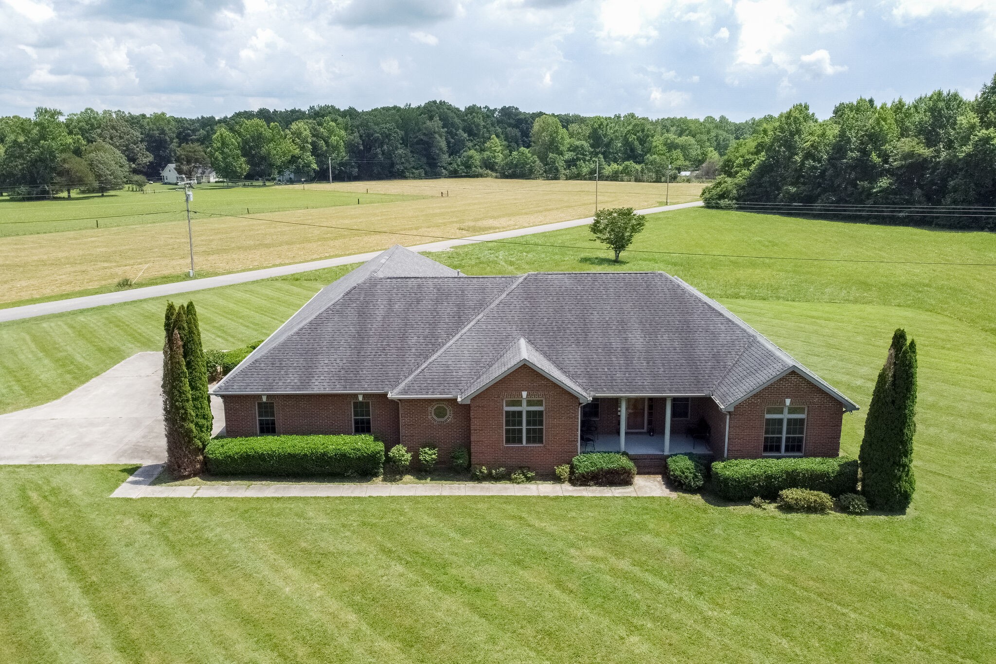 1169 Shedd Road Manchester, TN 37355 - Photo 1 of 36 a aerial view of a house with swimming pool and a yard