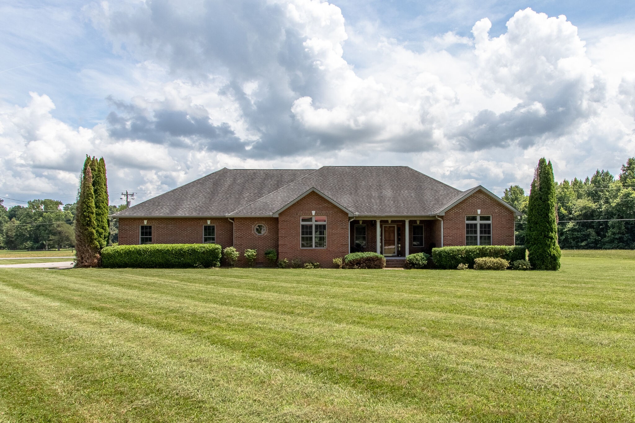 1169 Shedd Road Manchester, TN 37355 - Photo 2 of 36 a view of a big house with a big yard and large trees
