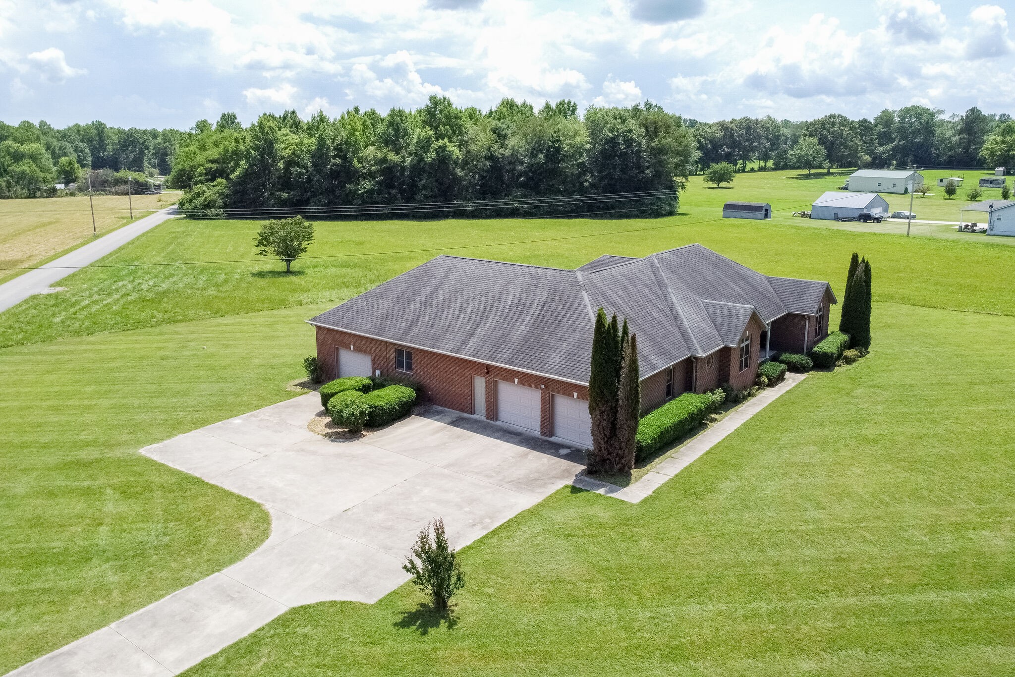 1169 Shedd Road Manchester, TN 37355 - Photo 26 of 36 a view of a house with yard and a garden