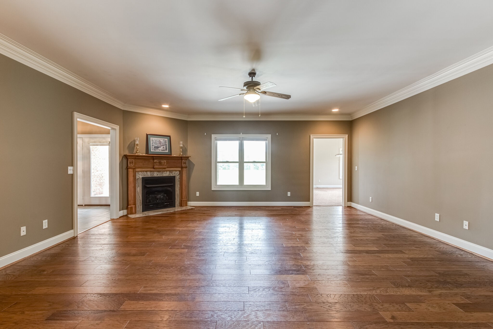 1169 Shedd Road Manchester, TN 37355 - Photo 6 of 36 a view of an empty room with wooden floor fireplace and a window