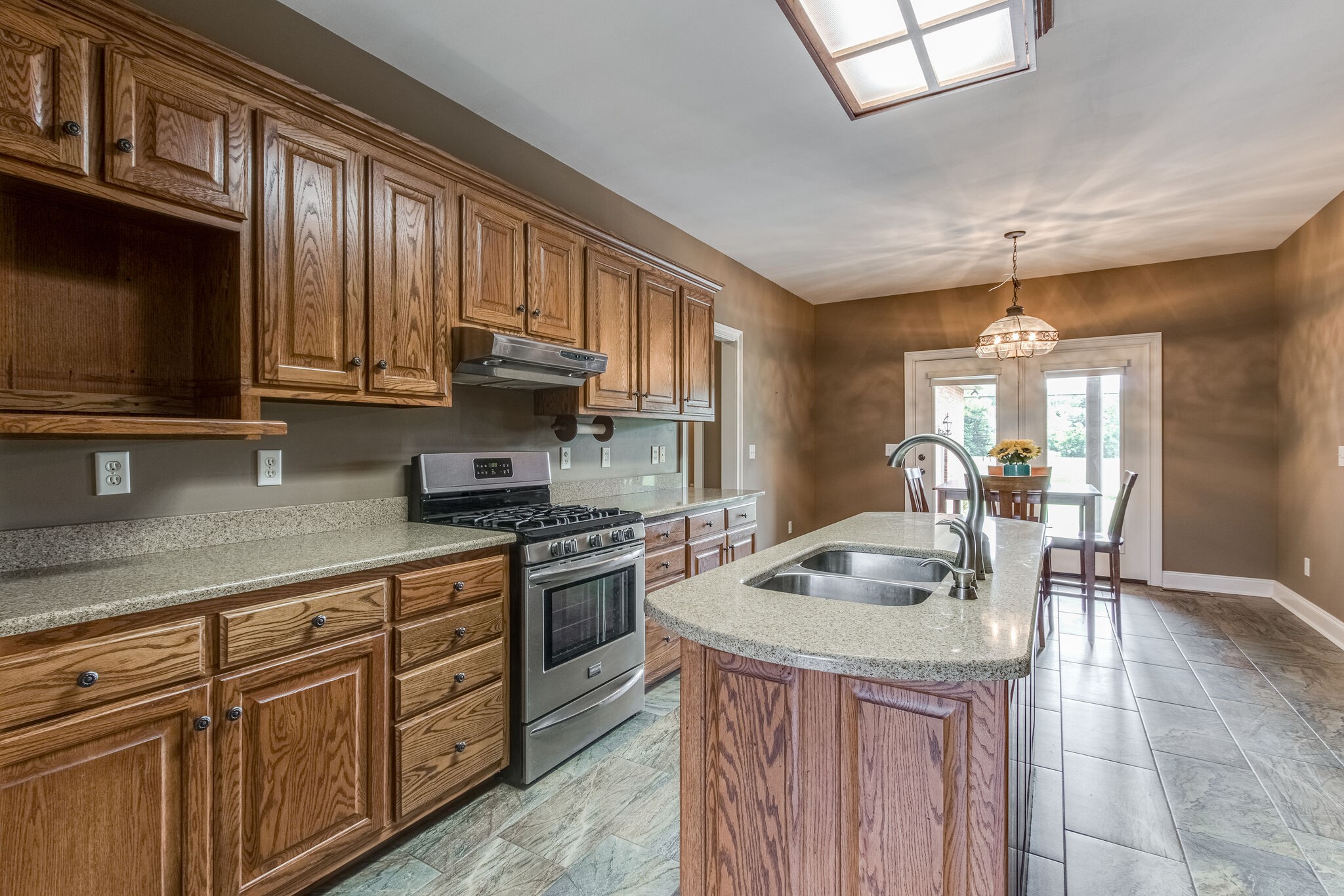 1169 Shedd Road Manchester, TN 37355 - Photo 10 of 36 a kitchen with granite countertop a sink stove and cabinets