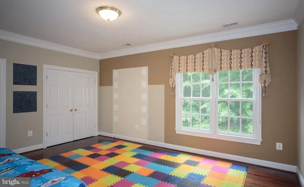 a living room with lots of furniture and a large window