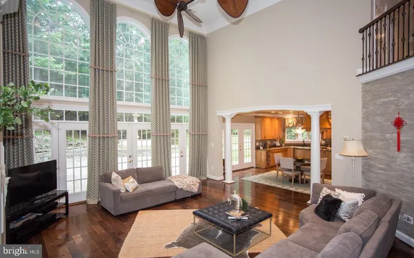 a living room with furniture and a floor to ceiling window
