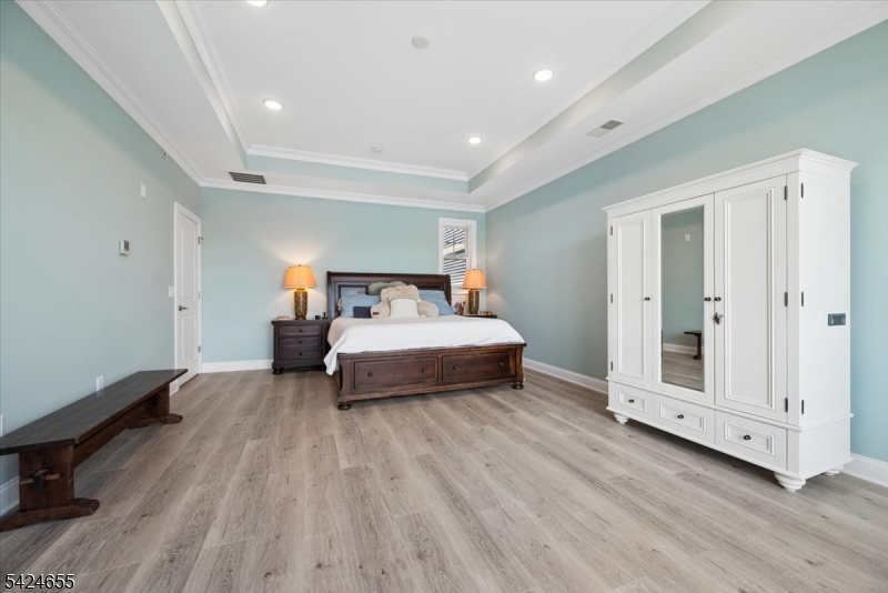 401 Mariners Pointe Hopatcong, NJ 07843 - Photo 32 of 42 a bedroom with a bed and wooden floor