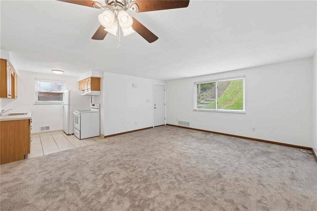 403 Homewood Avenue Trafford, PA 15085 - Photo 3 of 30 an empty room with chandelier fan and windows